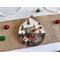ornament with Christmas tree background, includes buttons, cranberry pips, a stamp, mini ticket strip, and a mini ornament tag.
